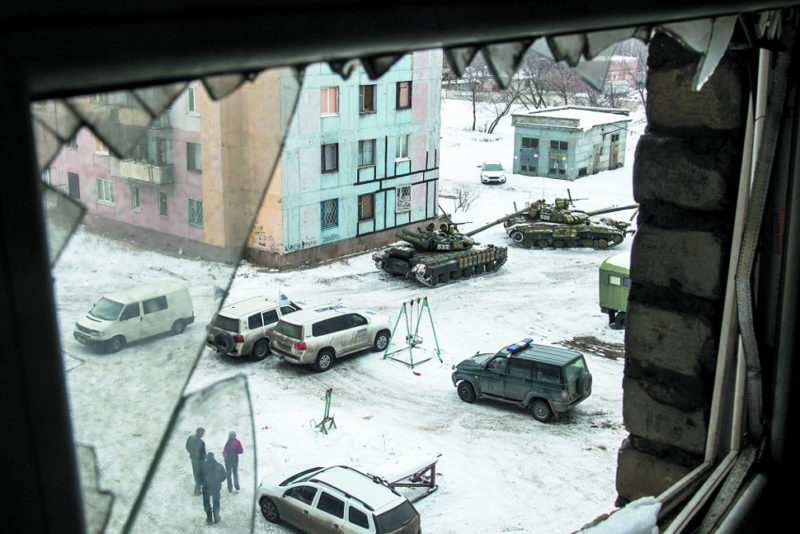 Ukrainian T-64 tanks near apartment buildings in Avdeyevka, close to the contact line and well inside the 15 kilometre forbidden zone. At least two vehicles belonging to the OSCE can be seen in this picture, as well as a black vehicle most likely belonging to Ukraine security forces. Photo: Evgueni Maloletka / TASS