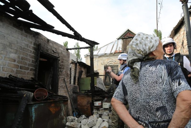 Civilian showing to OSCE monitors impact on her house by shelling in the Trudivske area of Donetsk City, July 20, 2017. Photo: OSCE / Mariia Aleksevych